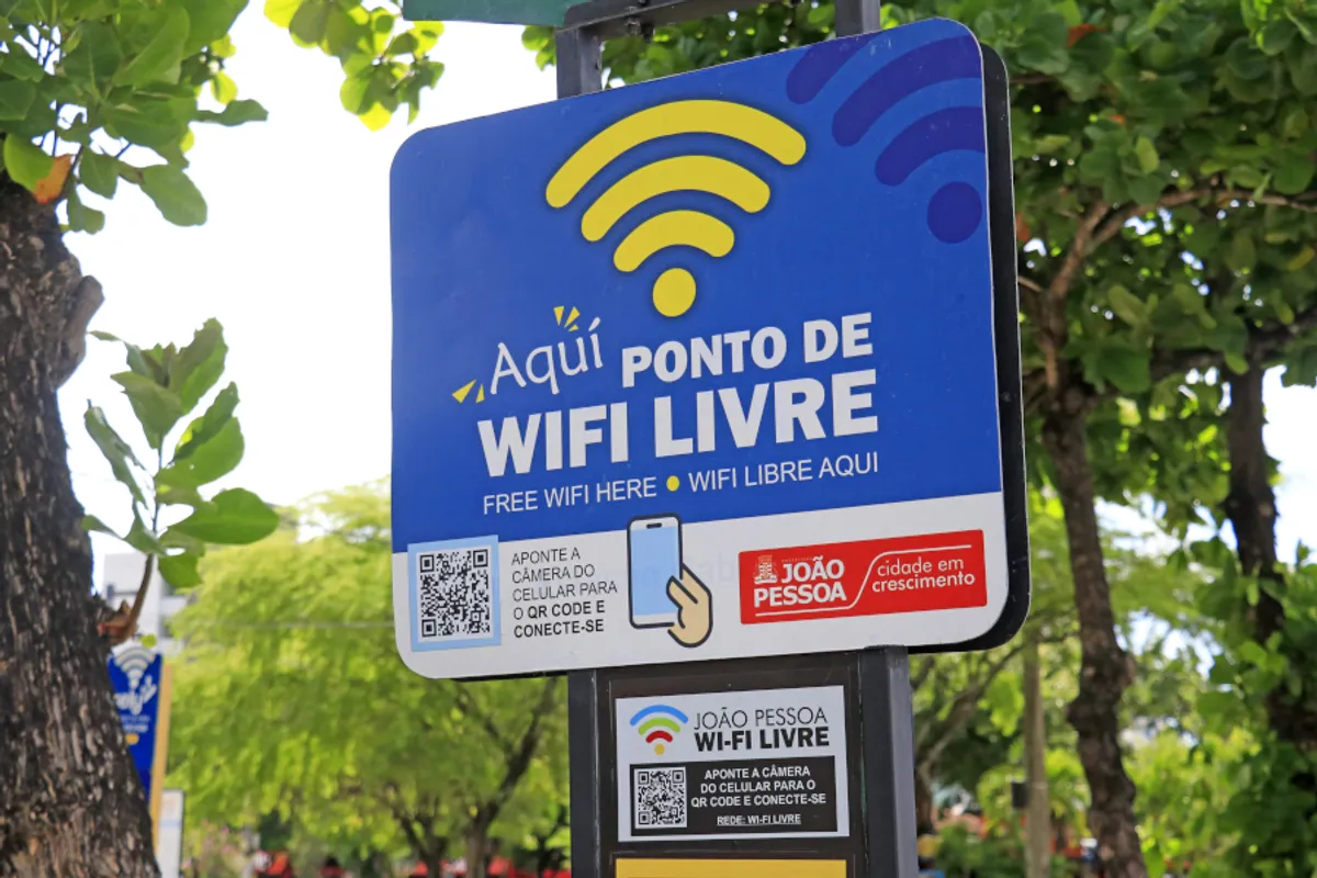 Pessoas utilizando pontos de internet gratuita em praça pública de João Pessoa
