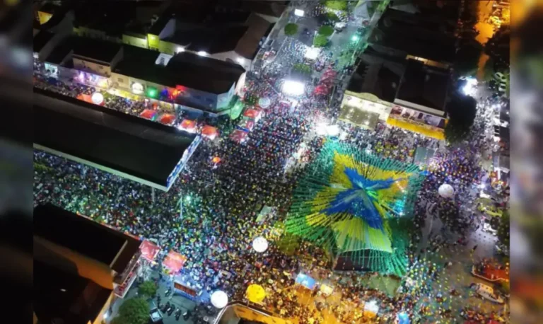 Palco iluminado e multidão em festival de São João