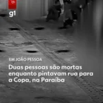 Rua em João Pessoa após ataque a tiros, com evidências de pintura comunitária e atmosfera tensa.